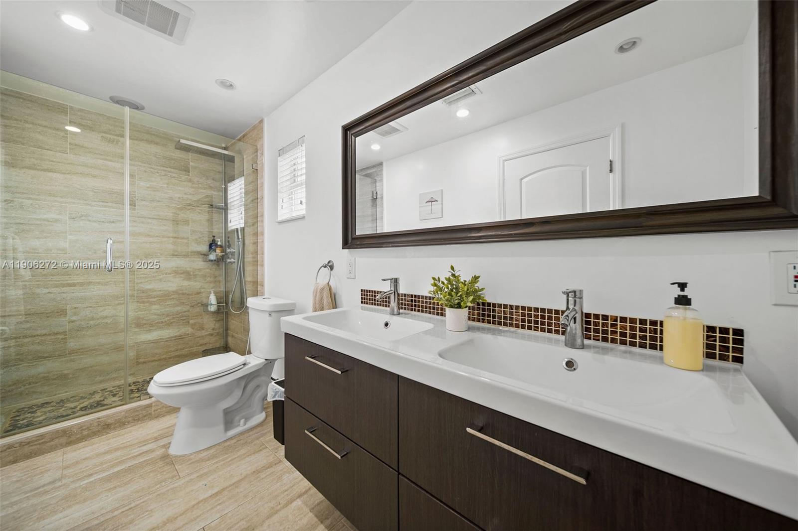 2761 Southwest 92nd Place Miami, FL 33165 - Photo 10 of 19 a bathroom with a sink a toilet and a mirror