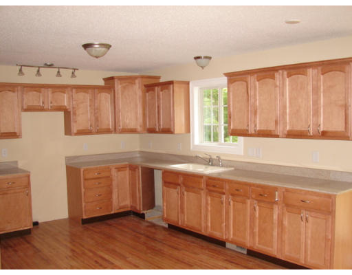 479 Montgomery Road Westfield, MA 01085 - Photo 2 of 11 a kitchen with granite countertop a stove a sink and dishwasher with wooden cabinets