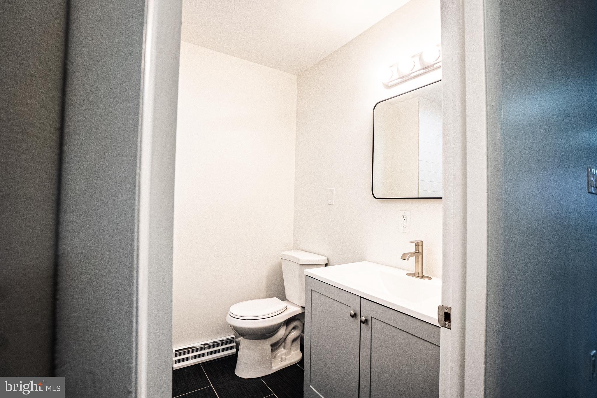 2306 Peter Cheeseman Road Sicklerville, NJ 08081 - Photo 13 of 26 a bathroom with a toilet sink vanity and mirror