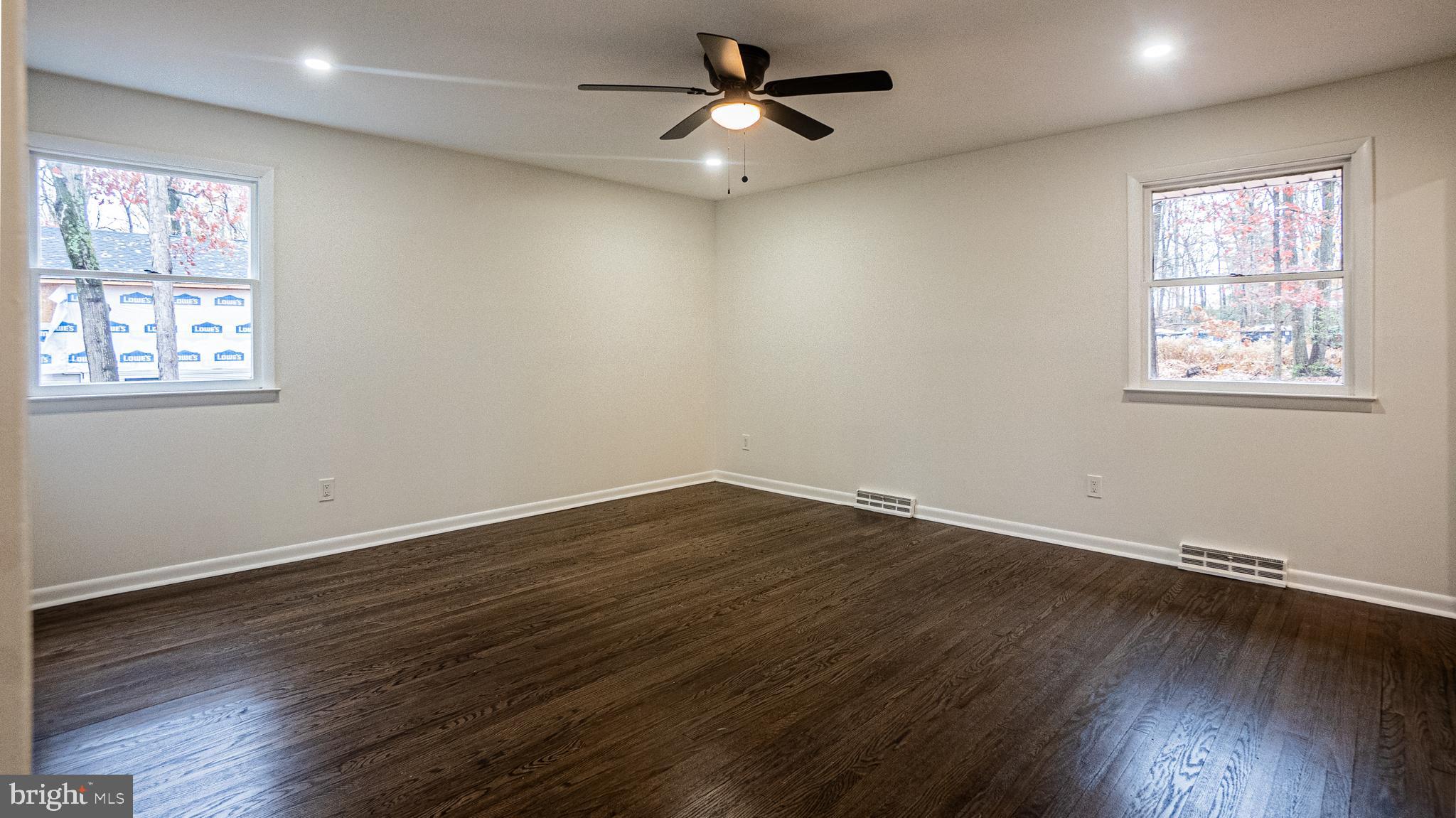 2306 Peter Cheeseman Road Sicklerville, NJ 08081 - Photo 14 of 26 a view of empty room with wooden floor and fan