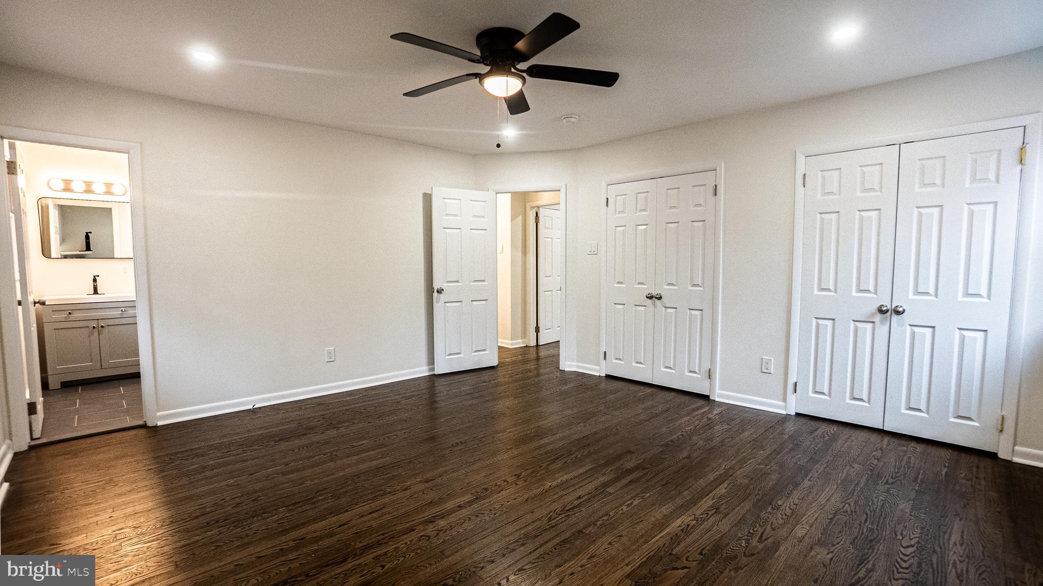 2306 Peter Cheeseman Road Sicklerville, NJ 08081 - Photo 15 of 26 a view of an empty room with wooden floor and a ceiling fan