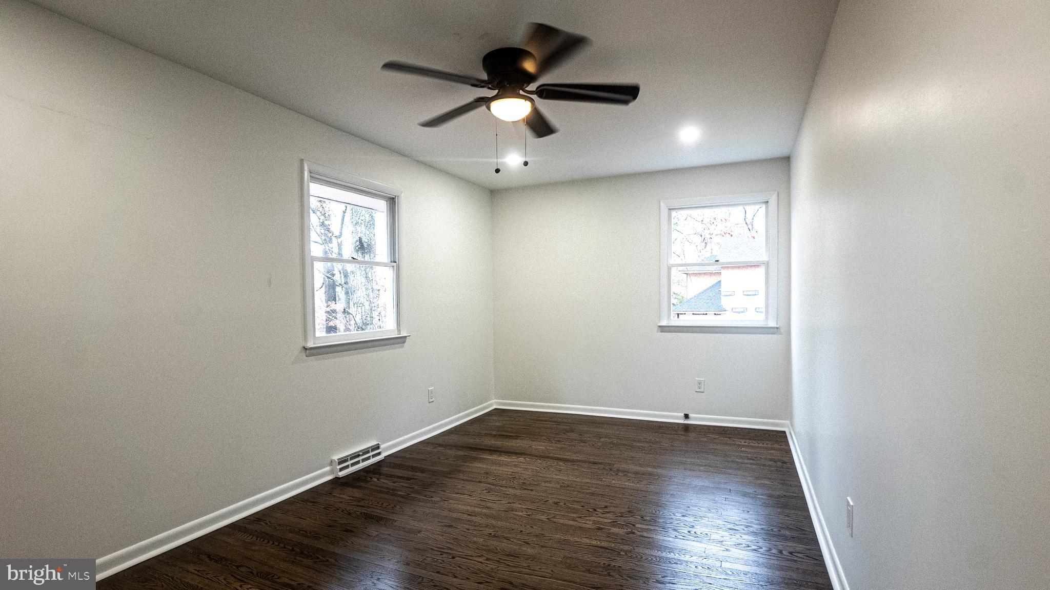 2306 Peter Cheeseman Road Sicklerville, NJ 08081 - Photo 18 of 26 an empty room with wooden floor and windows