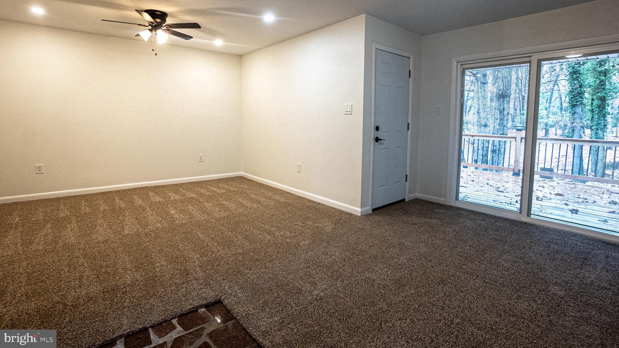 2306 Peter Cheeseman Road Sicklerville, NJ 08081 - Photo 8 of 26 an empty room with a ceiling fan and a window