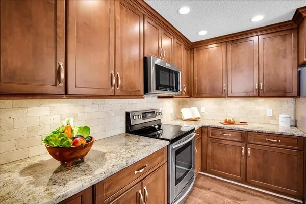 a spacious bedroom with a bed and wooden floor