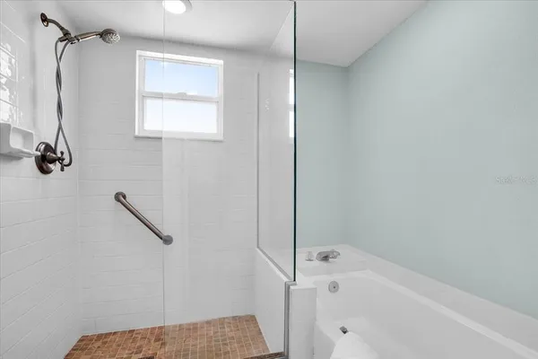 a bedroom with a bed and a ceiling fan