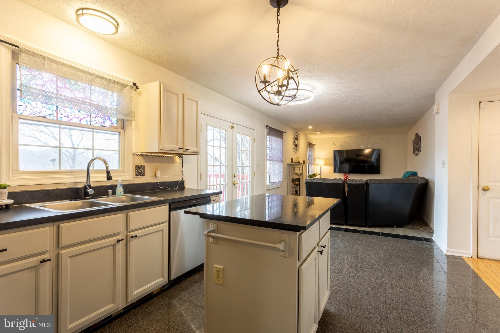 9525 Queens Guard Court Laurel, MD 20723 - Photo 11 of 36 a kitchen with stainless steel appliances granite countertop counter space a sink cabinets and a large window