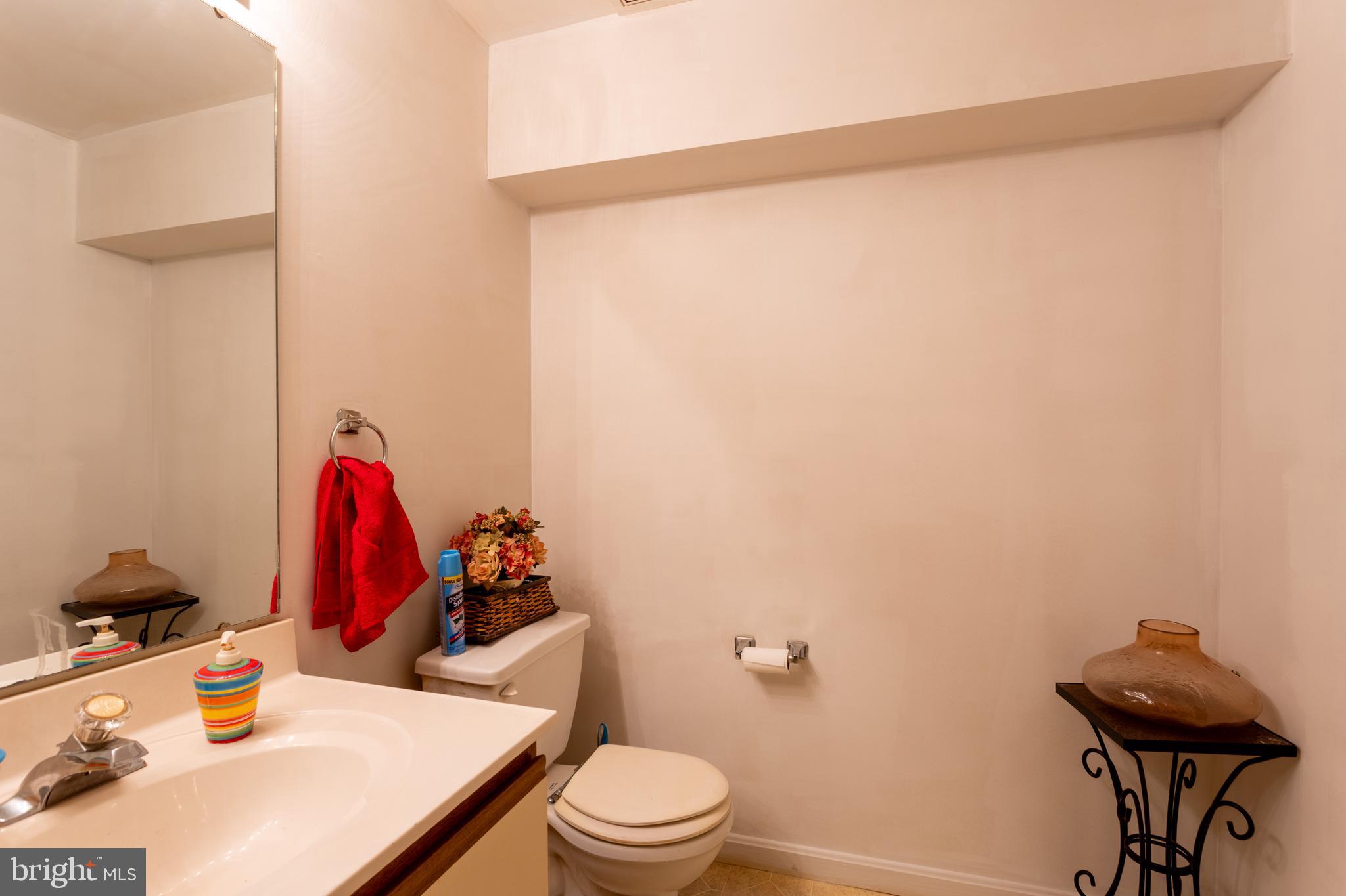 9525 Queens Guard Court Laurel, MD 20723 - Photo 15 of 36 a bathroom with a sink vanity mirror and toilet