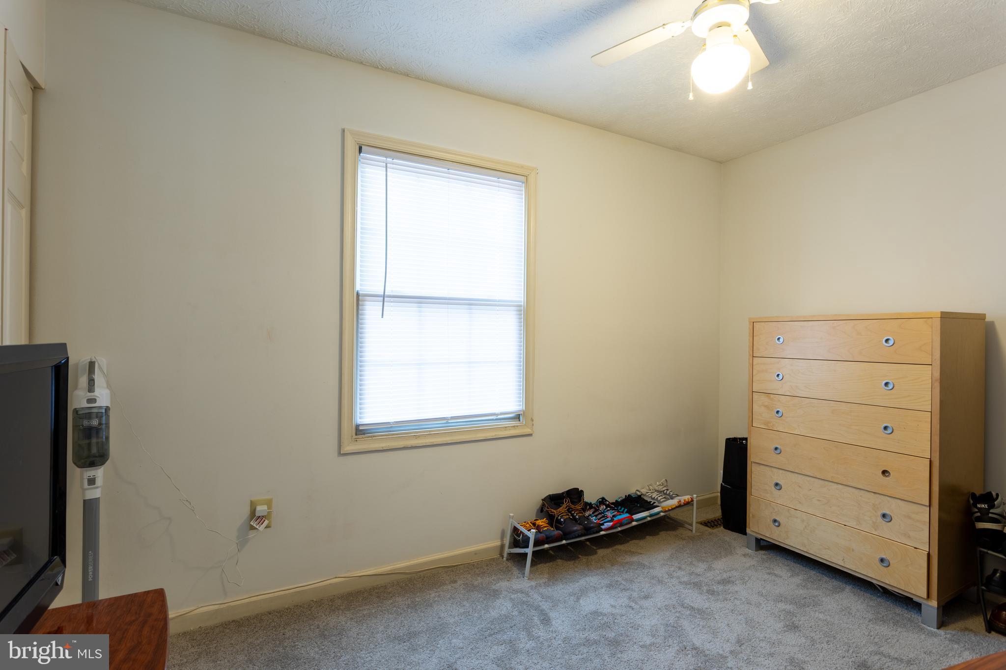 9525 Queens Guard Court Laurel, MD 20723 - Photo 20 of 36 a view of room with cabinet flat screen tv and windows