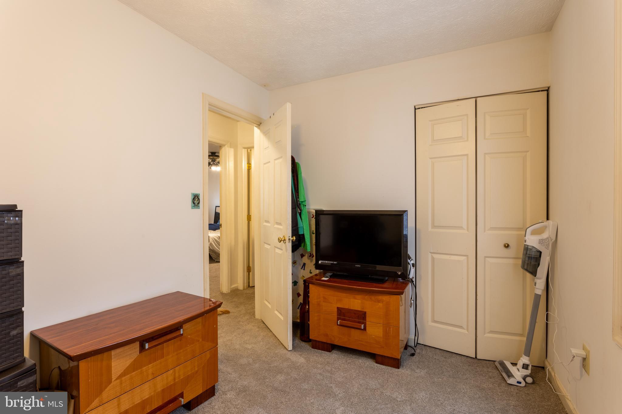9525 Queens Guard Court Laurel, MD 20723 - Photo 21 of 36 a living room with furniture and a flat screen tv