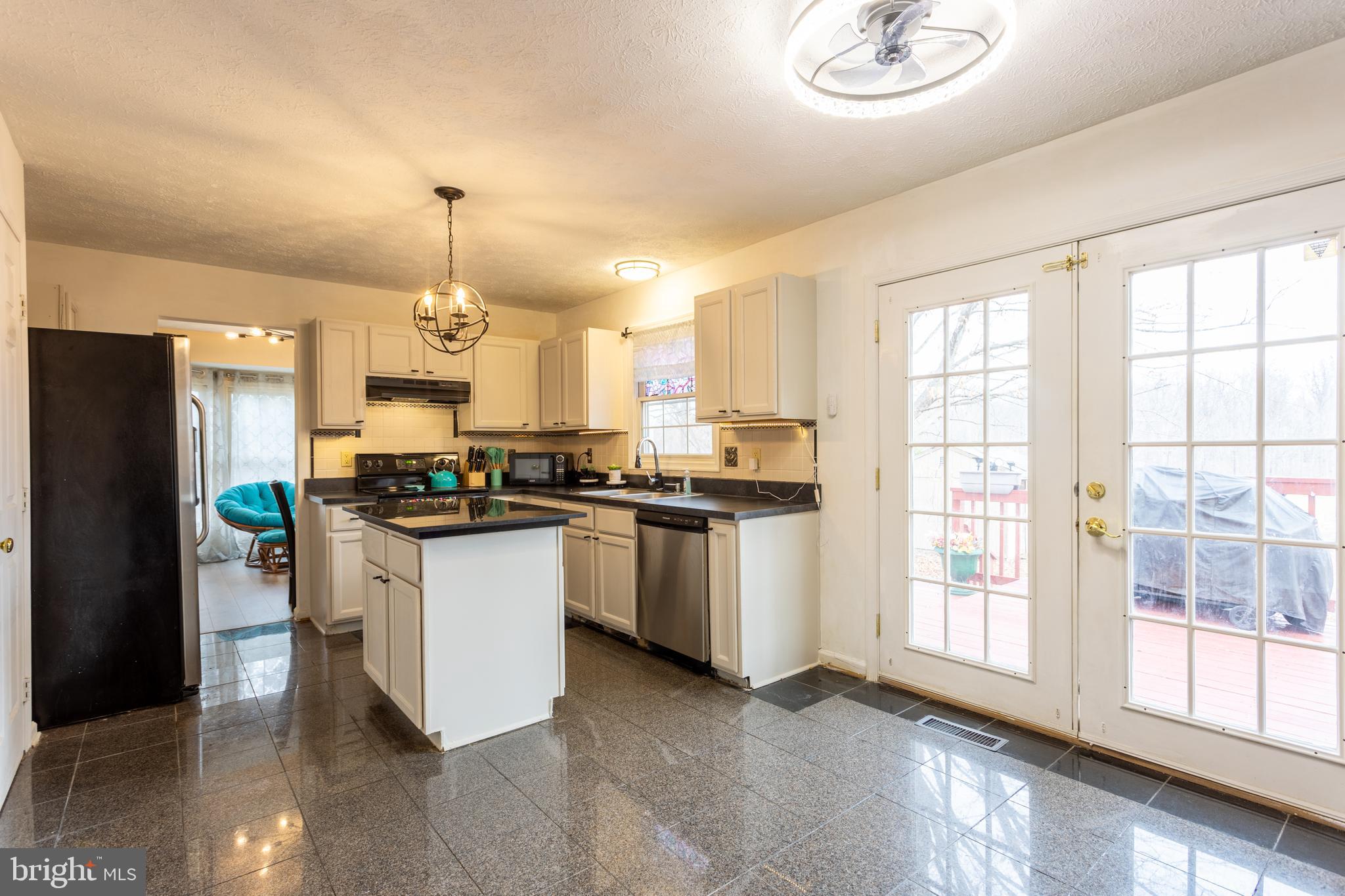 9525 Queens Guard Court Laurel, MD 20723 - Photo 9 of 36 a kitchen with a refrigerator a sink cabinets and wooden floor