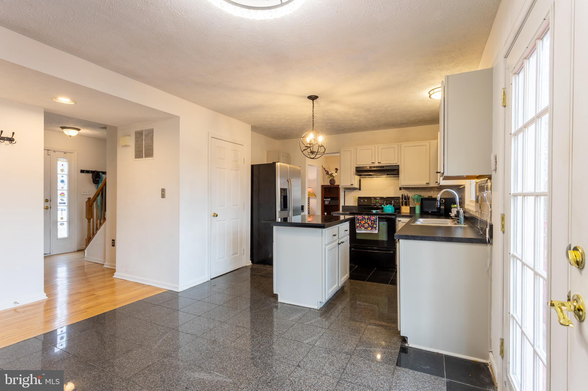 9525 Queens Guard Court Laurel, MD 20723 - Photo 10 of 36 a kitchen with a refrigerator and a stove