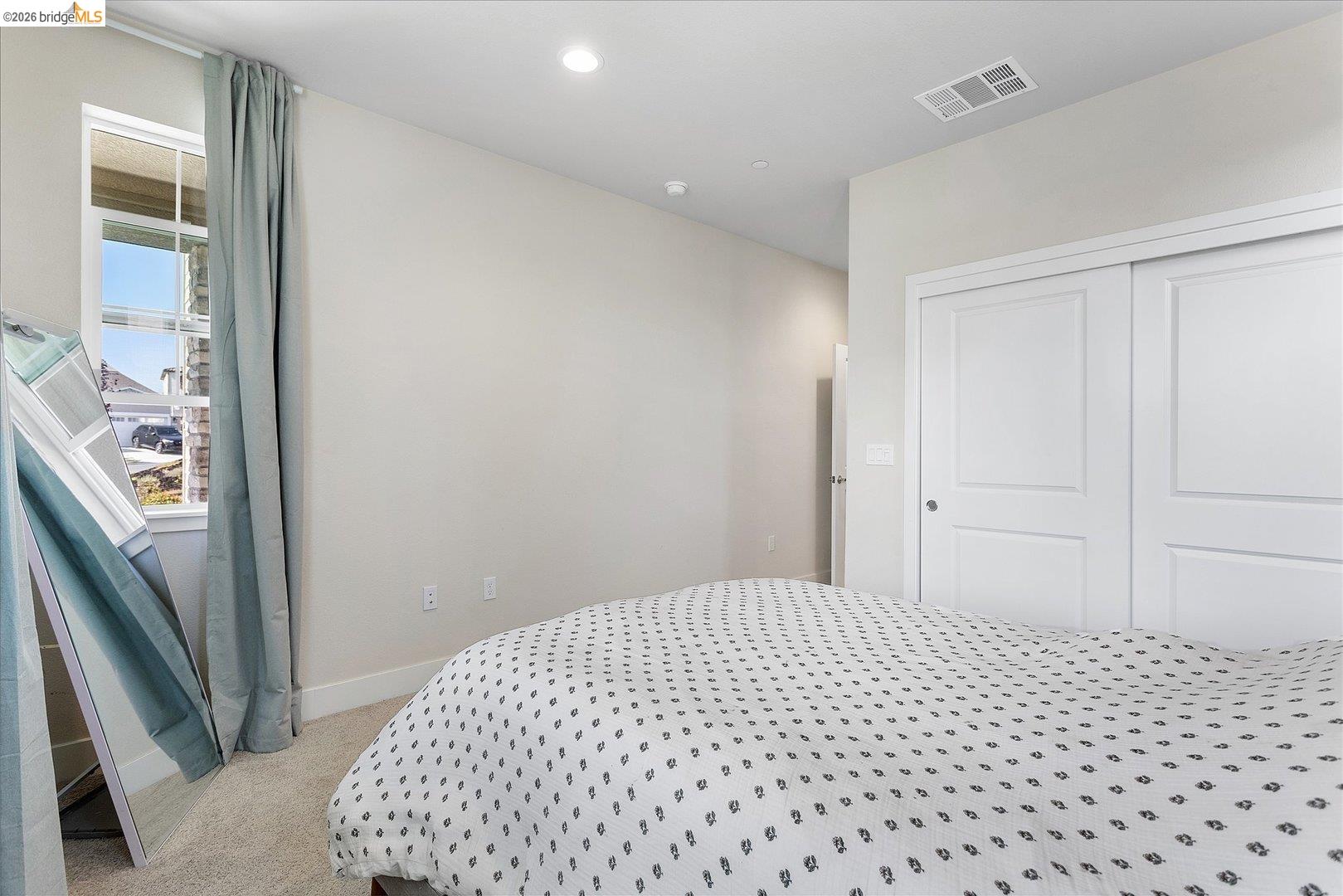 5601 Ridgepoint Way Antioch, CA 94531 - Photo 23 of 59 Bedroom featuring neutral wall paint, recessed lighting, carpet flooring, a window with vertical blinds, and a built-in closet with sliding panel doors