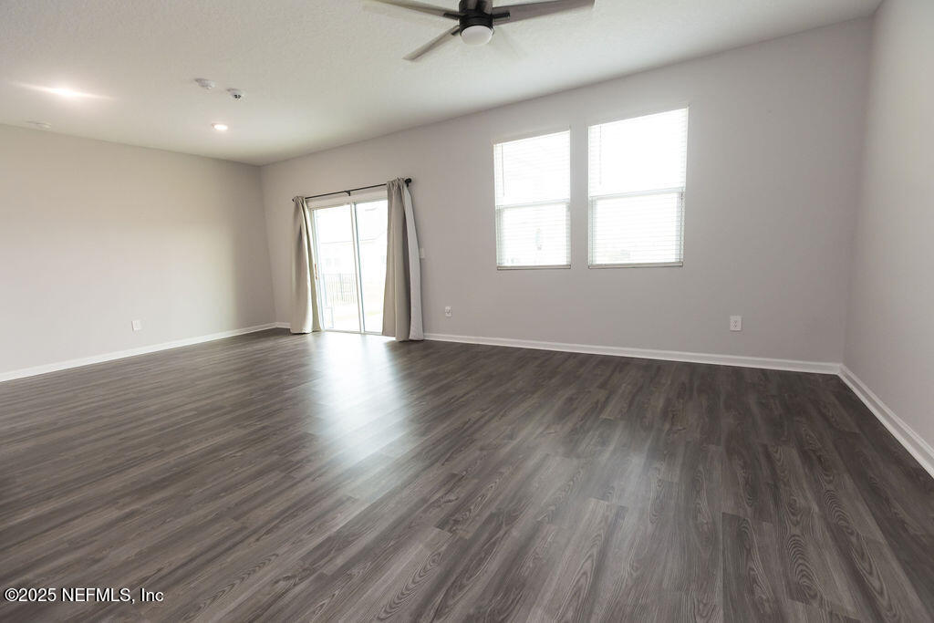 14655 Macadamia Lane Jacksonville, FL 32218 - Photo 13 of 24 an empty room with wooden floor and windows
