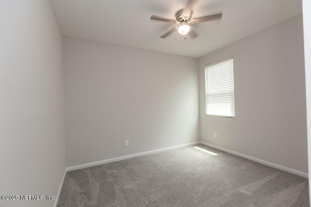 14655 Macadamia Lane Jacksonville, FL 32218 - Photo 16 of 24 an empty room with a window and a fan