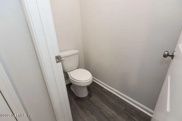 a white toilet sitting next to a sink