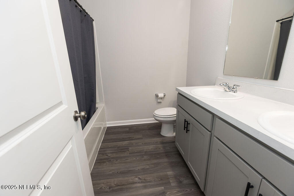14655 Macadamia Lane Jacksonville, FL 32218 - Photo 8 of 24 a bathroom with a sink a toilet a mirror and vanity