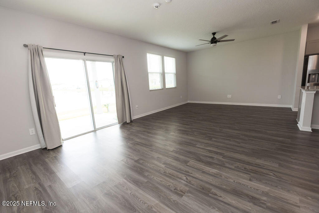 14655 Macadamia Lane Jacksonville, FL 32218 - Photo 10 of 24 an empty room with wooden floor and windows