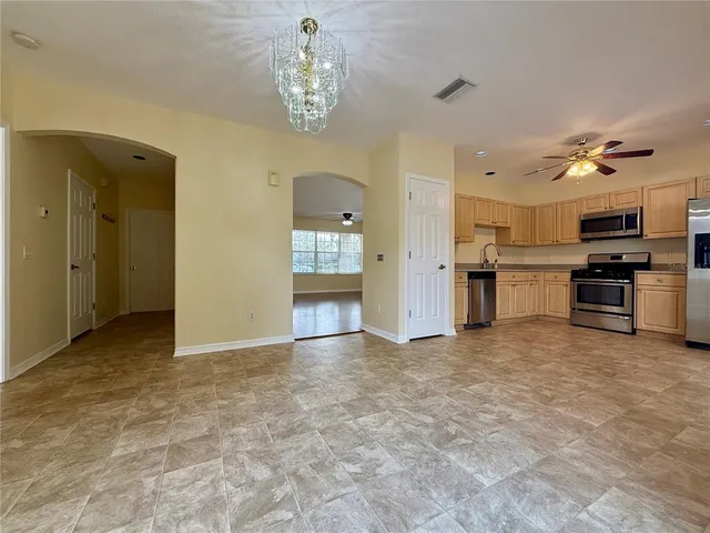a view of a kitchen with a sink and cabinets