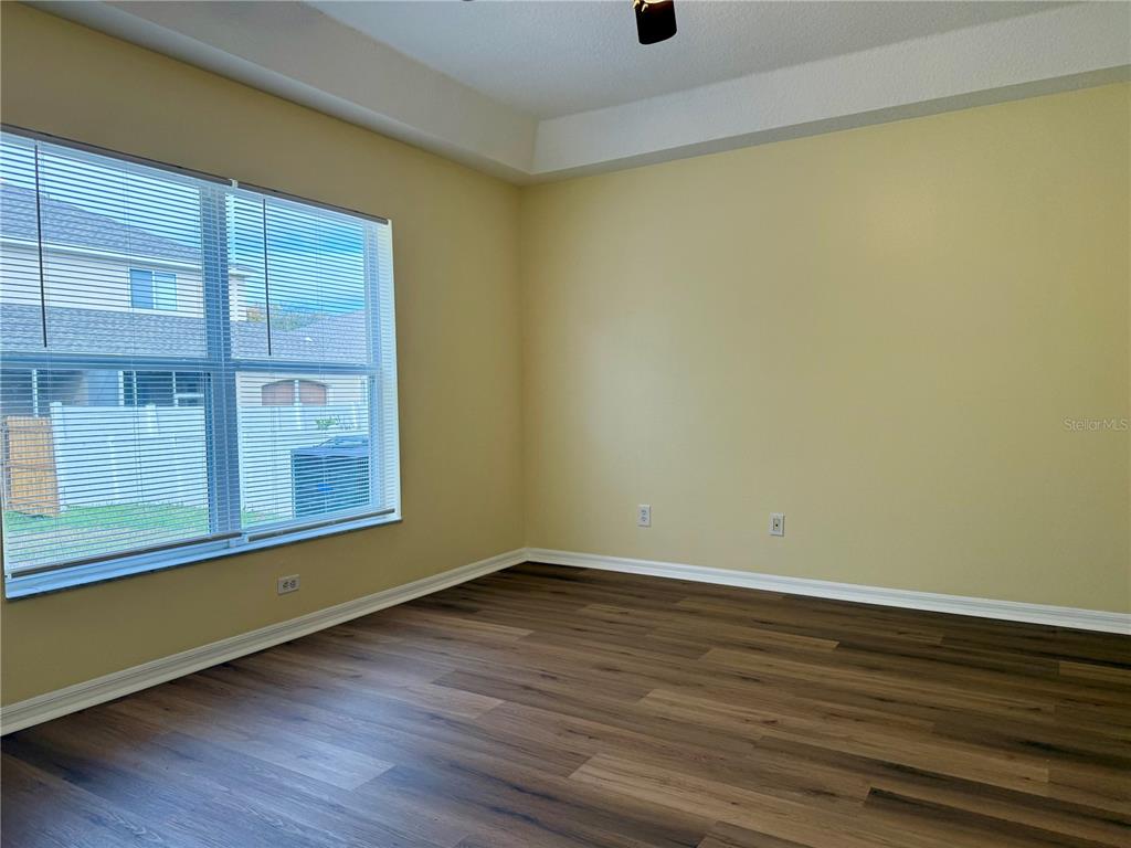 2521 Maylin Drive Trinity, FL 34655 - Photo 14 of 30 a view of an empty room with wooden floor and a window