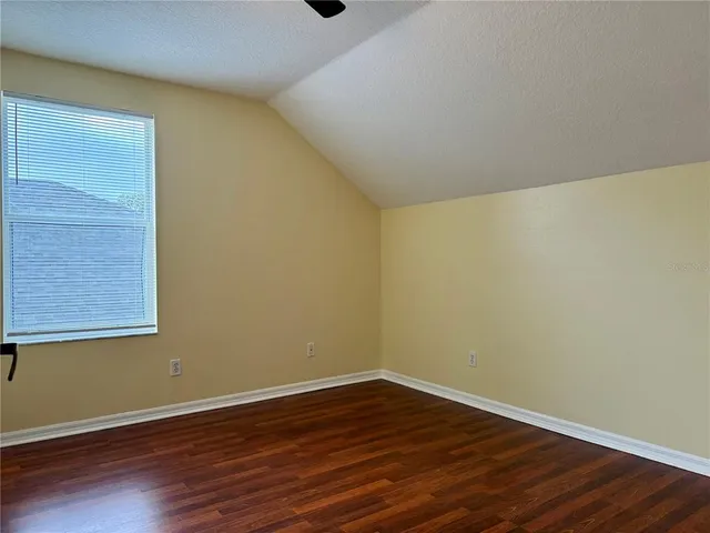 a view of a room with wooden floor and brick walls