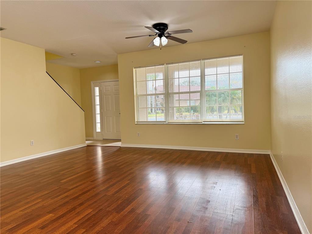 2521 Maylin Drive Trinity, FL 34655 - Photo 6 of 30 a view of an empty room with wooden floor and a window
