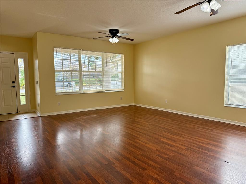 2521 Maylin Drive Trinity, FL 34655 - Photo 7 of 30 a view of an empty room with wooden floor and a window