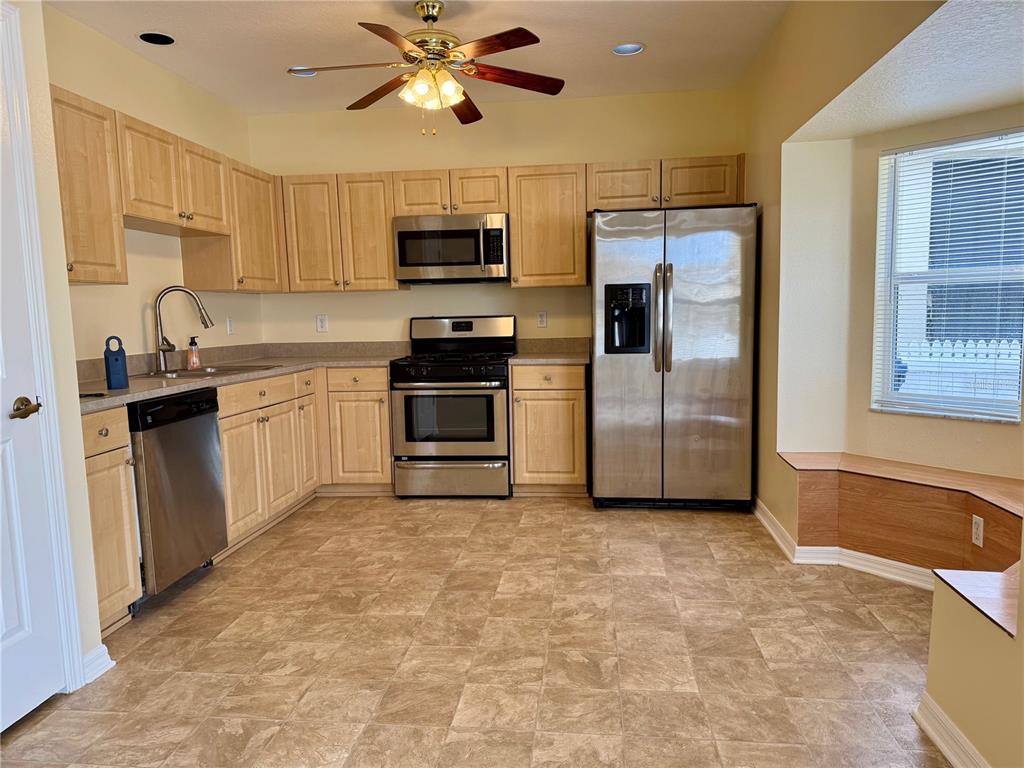 2521 Maylin Drive Trinity, FL 34655 - Photo 8 of 30 a kitchen with stainless steel appliances granite countertop a stove a sink and a refrigerator