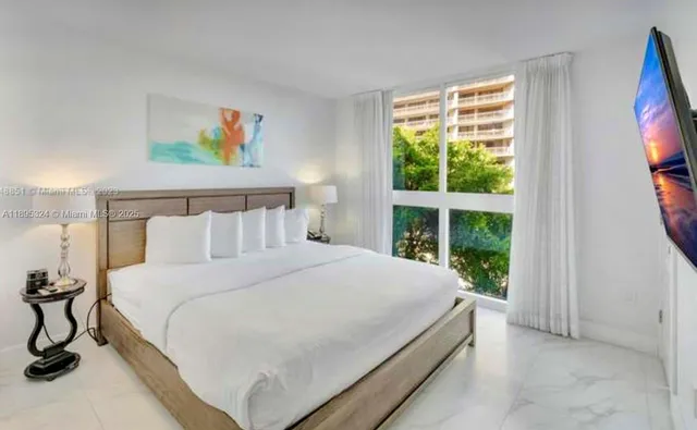 a view of a backyard with plants and a patio