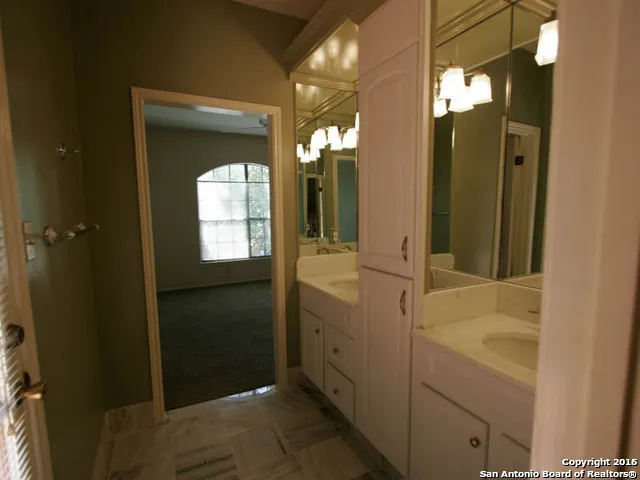 a bathroom with a sink vanity and mirror