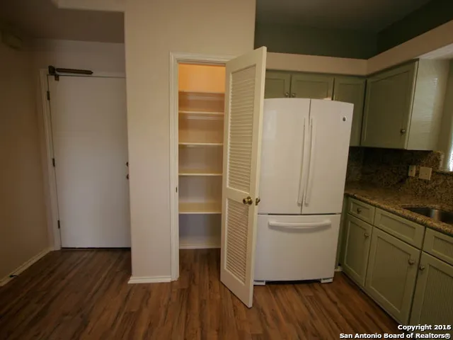 a white refrigerator freezer sitting inside of a kitchen