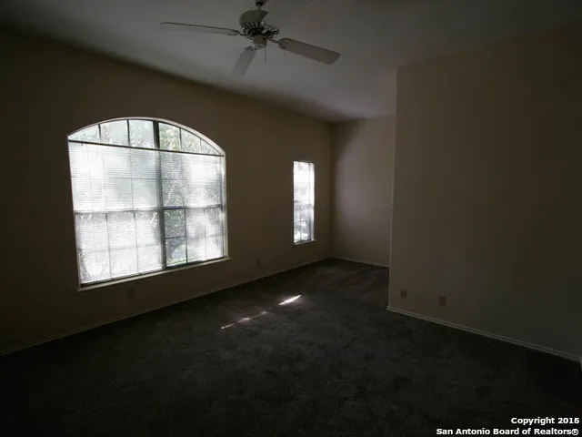 an empty room with a empty space and windows