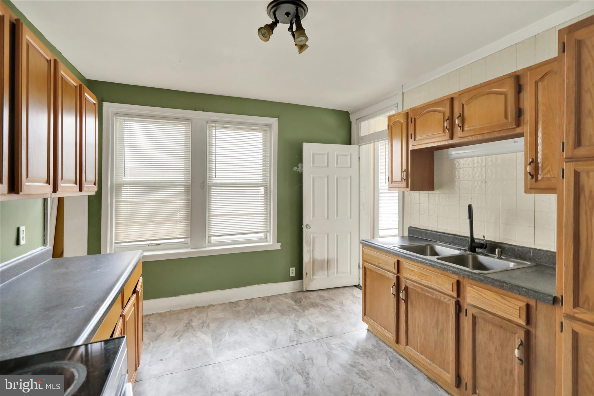 645 Lancaster Avenue Reading, PA 19611 - Photo 16 of 36 a spacious bathroom with a granite countertop sink and a mirror