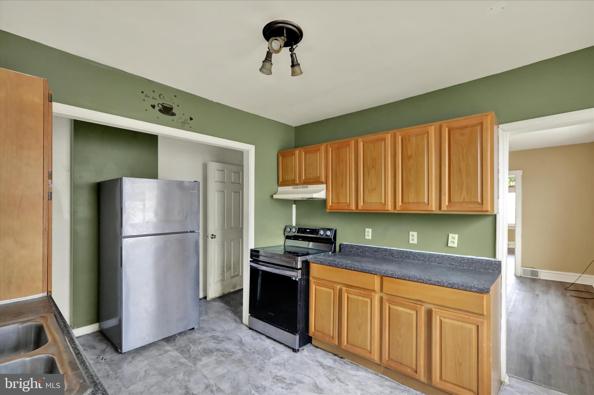 645 Lancaster Avenue Reading, PA 19611 - Photo 17 of 36 a kitchen with stainless steel appliances granite countertop a refrigerator sink and cabinets