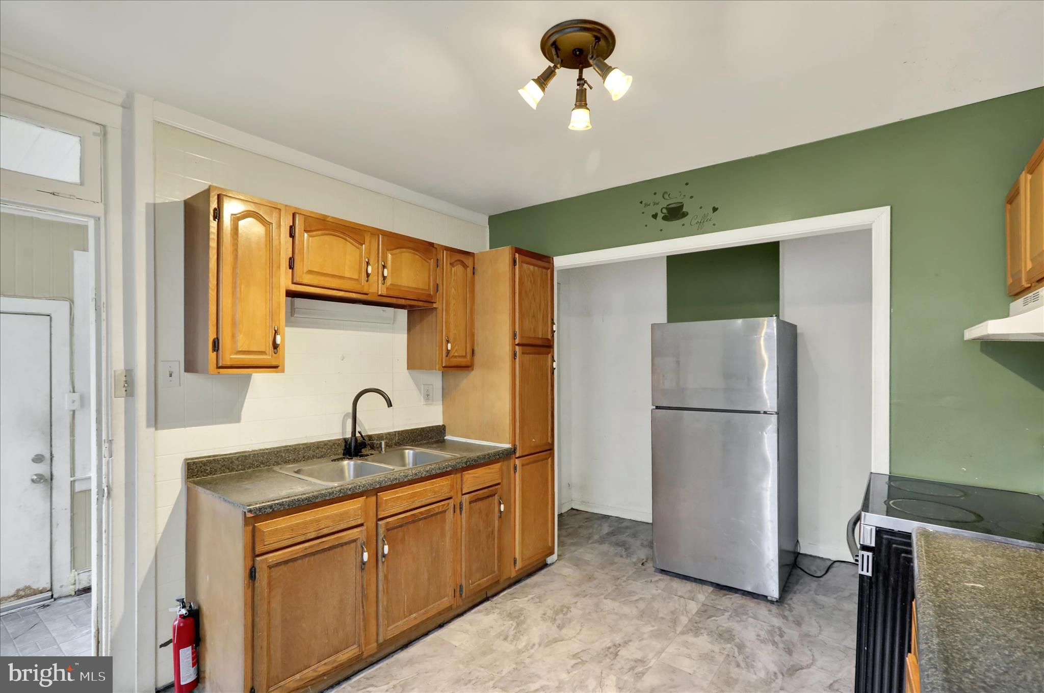 645 Lancaster Avenue Reading, PA 19611 - Photo 19 of 36 a kitchen with a refrigerator and a sink