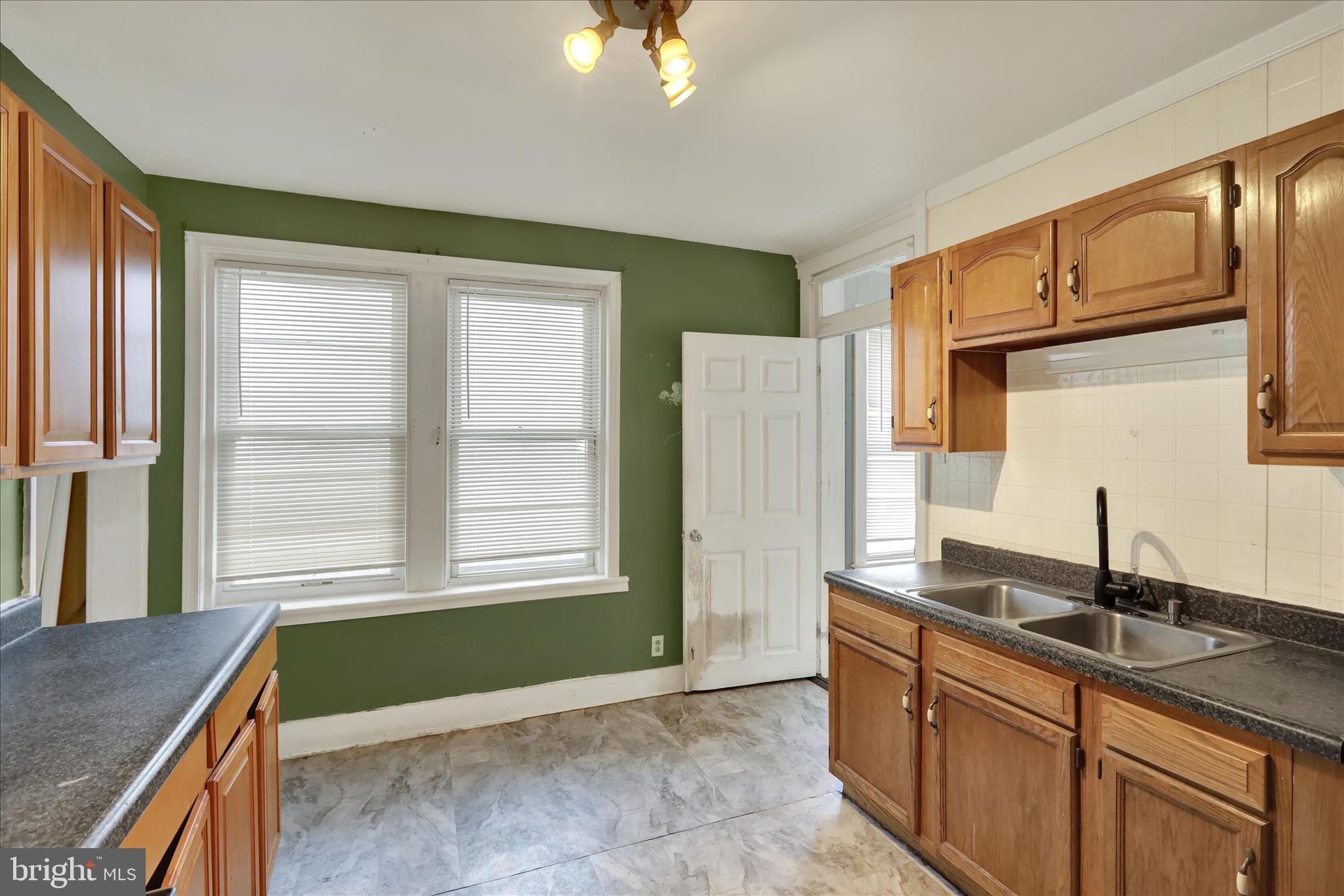 645 Lancaster Avenue Reading, PA 19611 - Photo 21 of 36 a bathroom with a sink and a large mirror