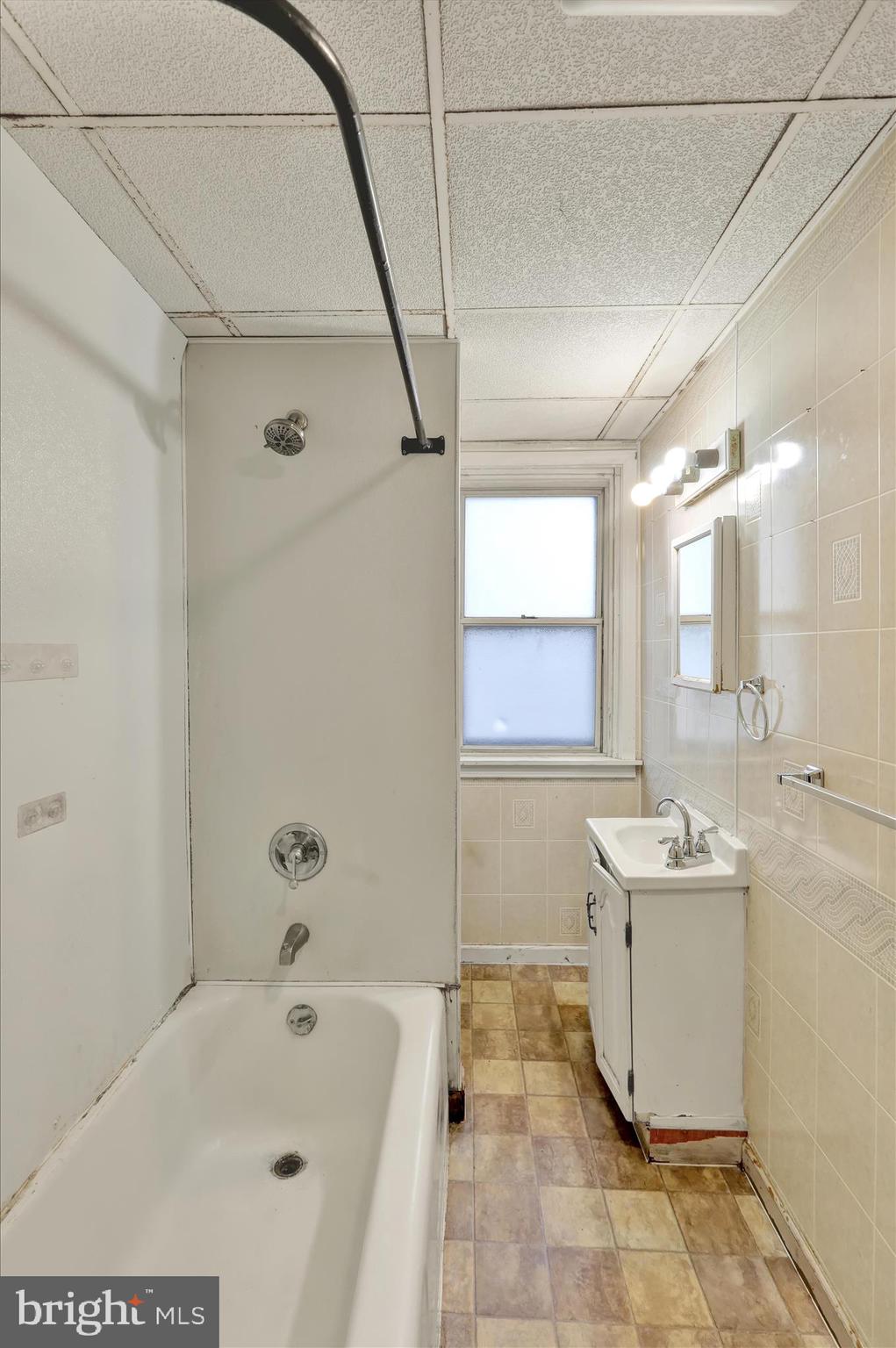 645 Lancaster Avenue Reading, PA 19611 - Photo 30 of 36 a bathroom with a sink and mirror with bathtub