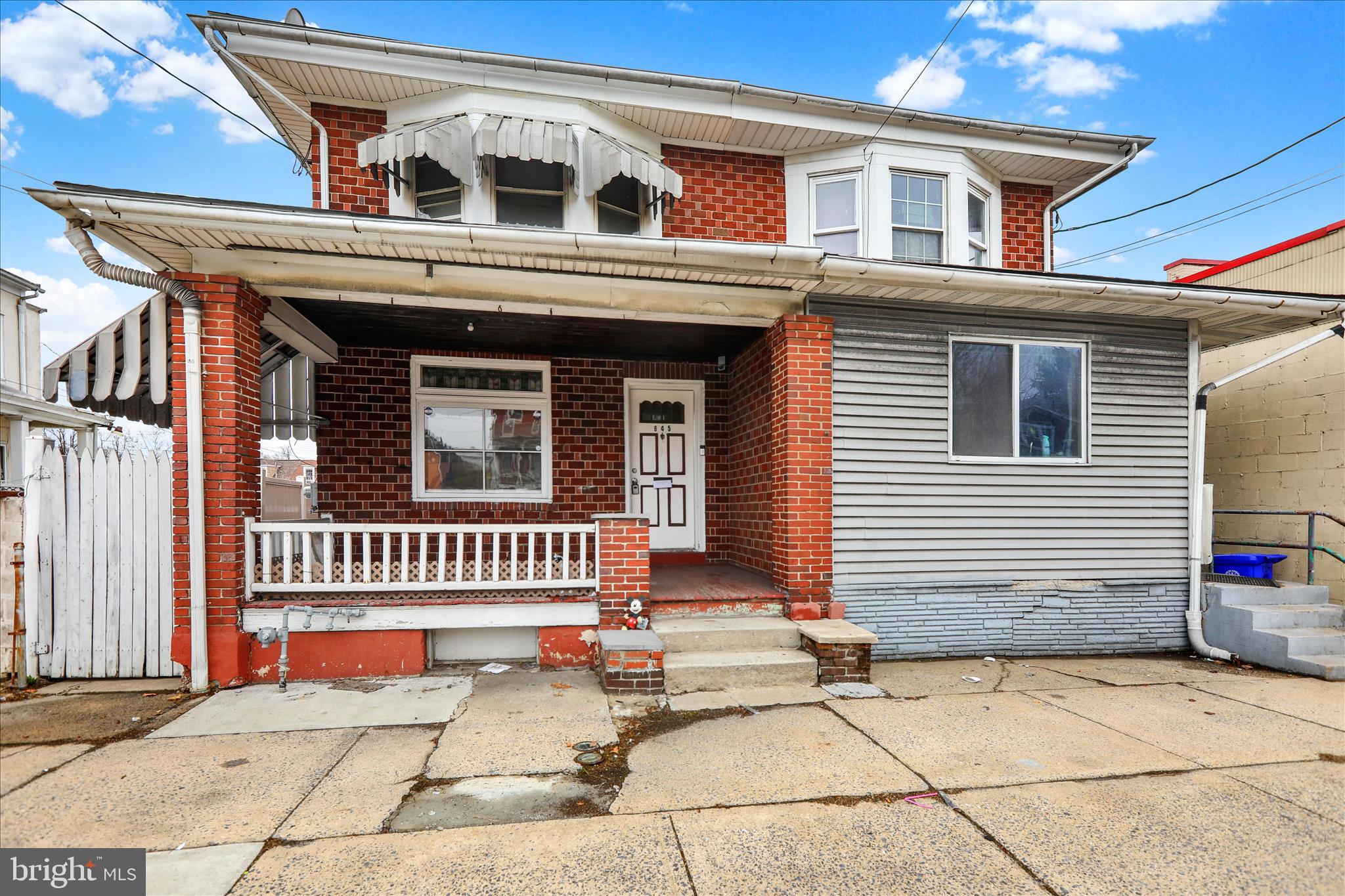 645 Lancaster Avenue Reading, PA 19611 - Photo 3 of 36 a front view of a house with a porch