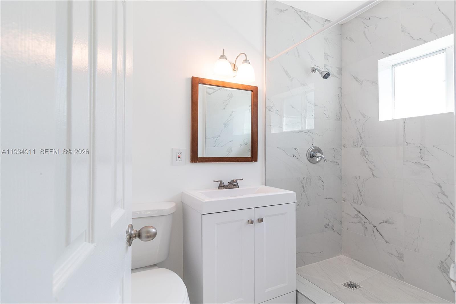 8430 Harding Avenue, Unit 4A Miami Beach, FL 33141 - Photo 12 of 43 a bathroom with a sink toilet and shower