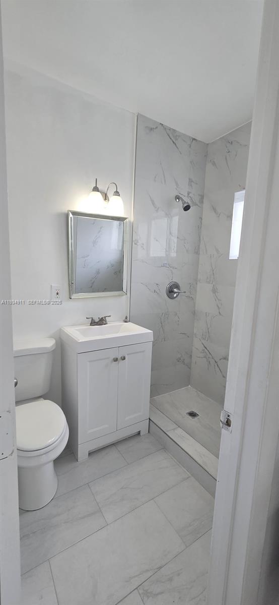 8430 Harding Avenue, Unit 4A Miami Beach, FL 33141 - Photo 15 of 43 a view of bathroom with a toilet sink and mirror