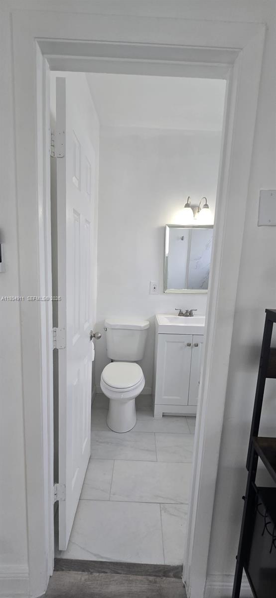 8430 Harding Avenue, Unit 4A Miami Beach, FL 33141 - Photo 16 of 43 a white toilet sitting next to a bathroom sink