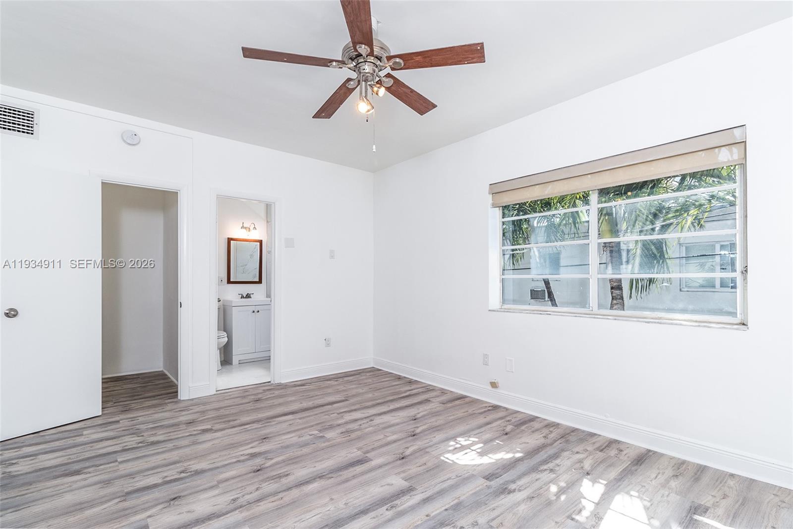 8430 Harding Avenue, Unit 4A Miami Beach, FL 33141 - Photo 2 of 43 a view of empty room with wooden floor and fan