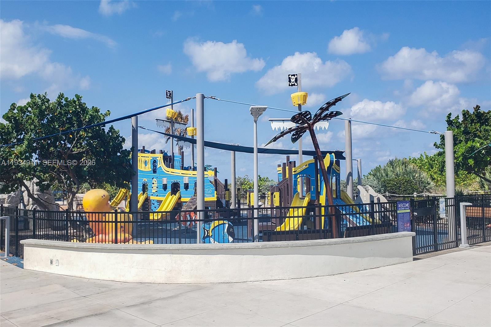 8430 Harding Avenue, Unit 4A Miami Beach, FL 33141 - Photo 31 of 43 a view of a park with swings and slides