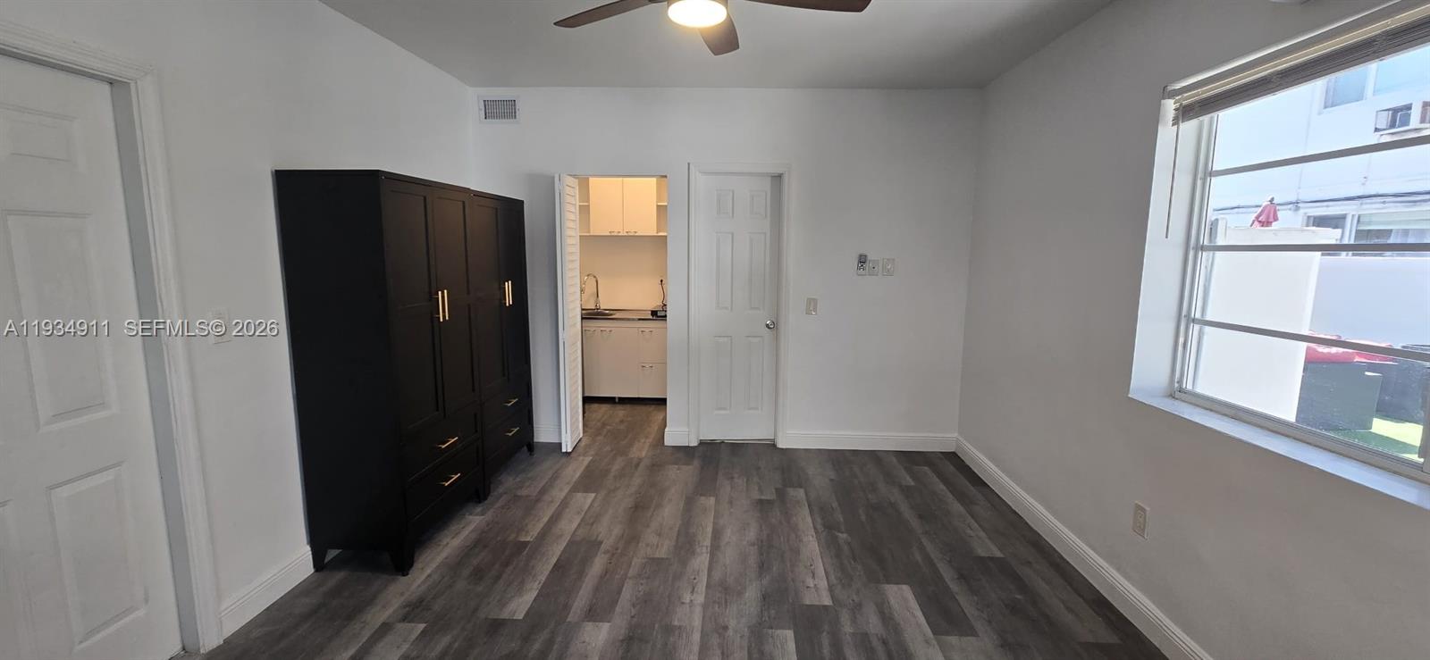 8430 Harding Avenue, Unit 4A Miami Beach, FL 33141 - Photo 4 of 43 wooden floor in an empty room with a window