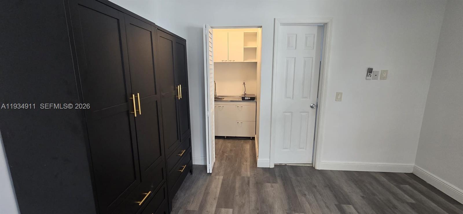 8430 Harding Avenue, Unit 4A Miami Beach, FL 33141 - Photo 5 of 43 a view of a hallway with wooden floor