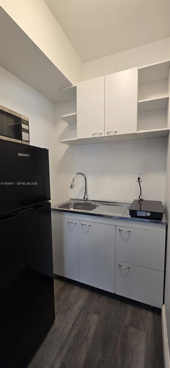 8430 Harding Avenue, Unit 4A Miami Beach, FL 33141 - Photo 9 of 43 a kitchen with granite countertop white cabinets and a sink