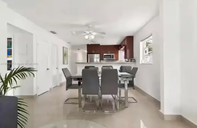 a view of a dining room with furniture and a kitchen