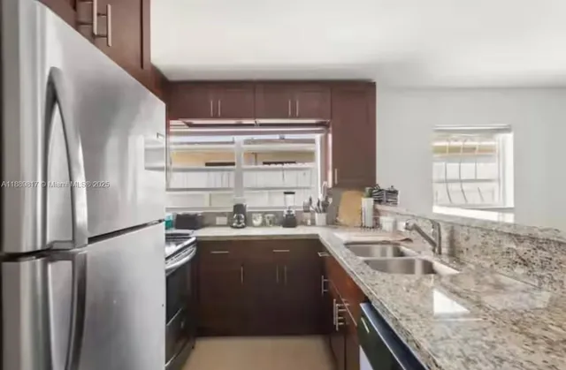 a kitchen with a sink stove and refrigerator