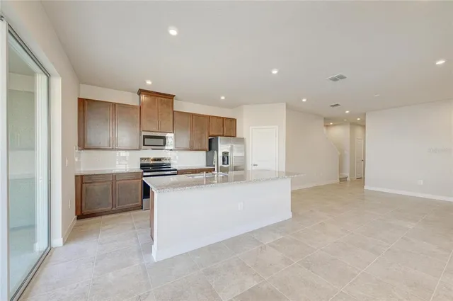 a kitchen with stainless steel appliances a sink stove and refrigerator