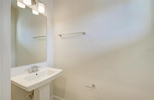 a bathroom with a sink a mirror and shower