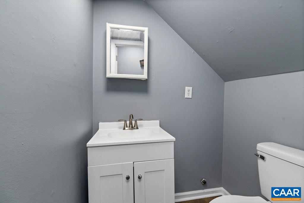 904 Rockcreek Road Charlottesville, VA 22903 - Photo 13 of 25 a bathroom with a sink toilet and a mirror